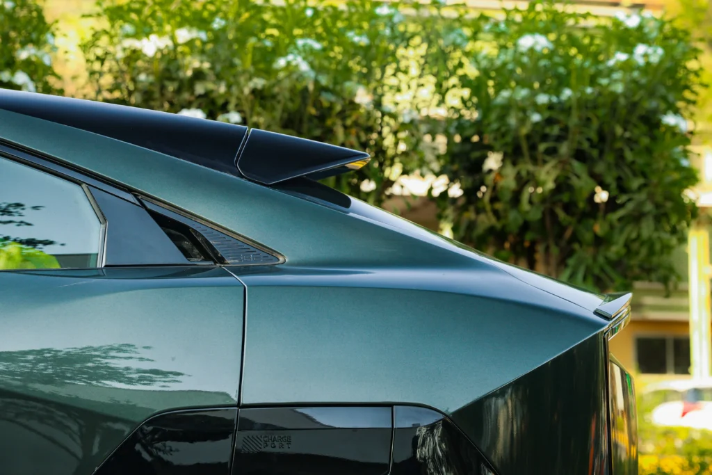 Mahindra BE6 Pack Two rear side view showing sleek coupe roofline and aerodynamic spoiler