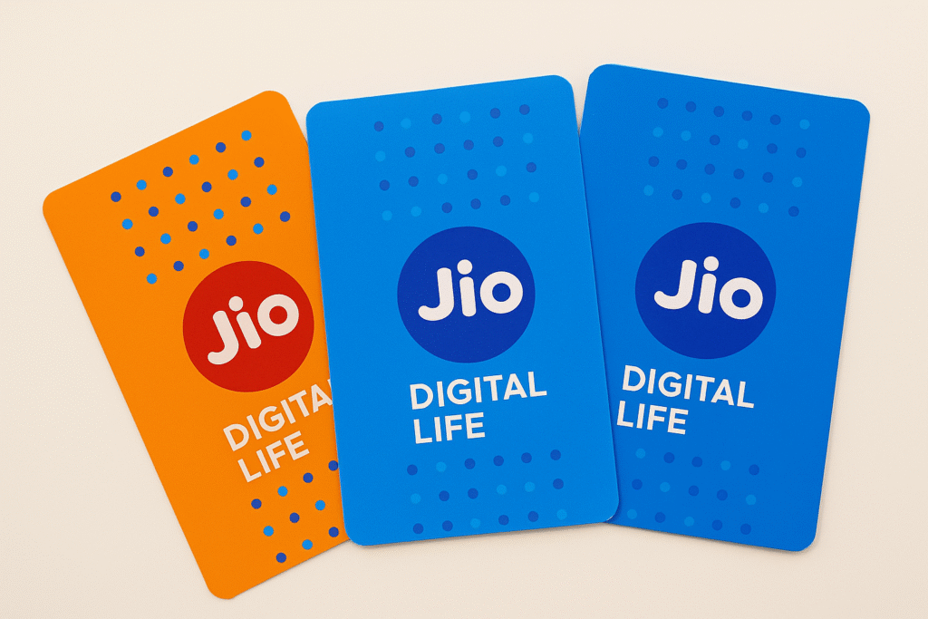 Three Reliance Jio SIM card packets in orange and blue with “Digital Life” branding, arranged neatly on a light surface representing Jio’s vibrant digital ecosystem.