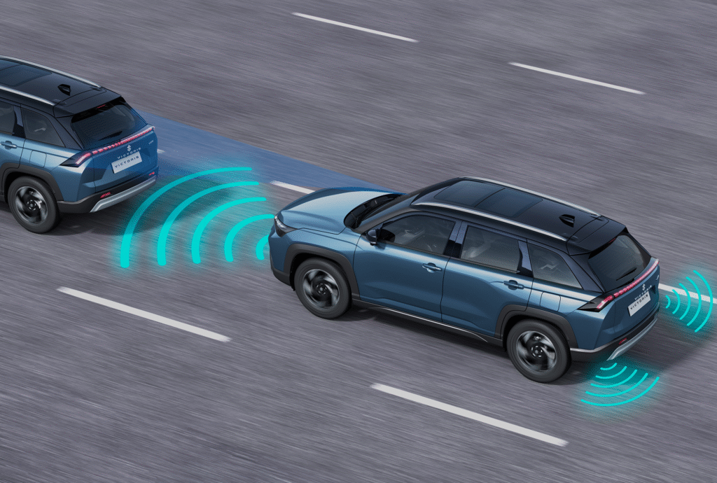 Maruti Suzuki Victoris SUV demonstrating advanced driver assistance system with radar sensors detecting distance from the vehicle ahead on a highway.