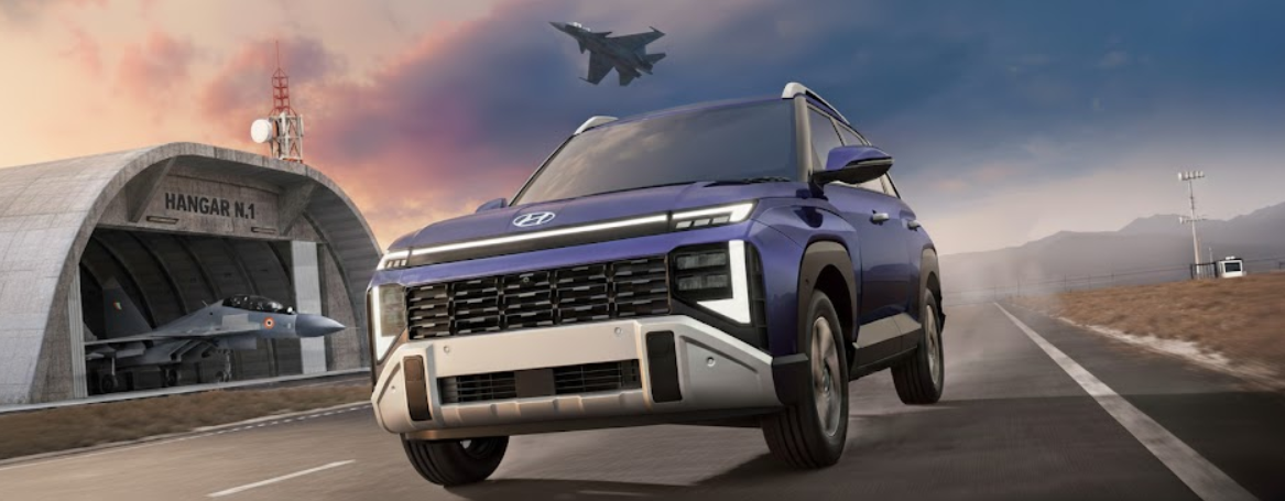 New Hyundai Venue 2025 driving on a runway with a fighter jet flying above and a hangar in the background