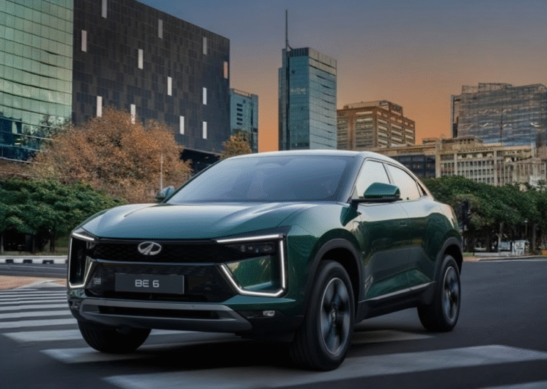 Mahindra BE6 Pack Two electric SUV on city road with modern buildings in the background