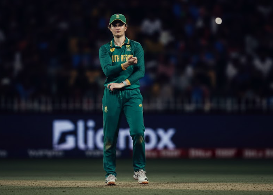 South Africa vs England Women’s World Cup 2025 — Laura Wolvaardt  in green and yellow kit prepares to bowl during the semi-final under stadium lights.