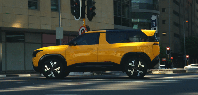 Tata Sierra 2025 in yellow color spotted in an urban city street showcasing its futuristic design and SUV stance.