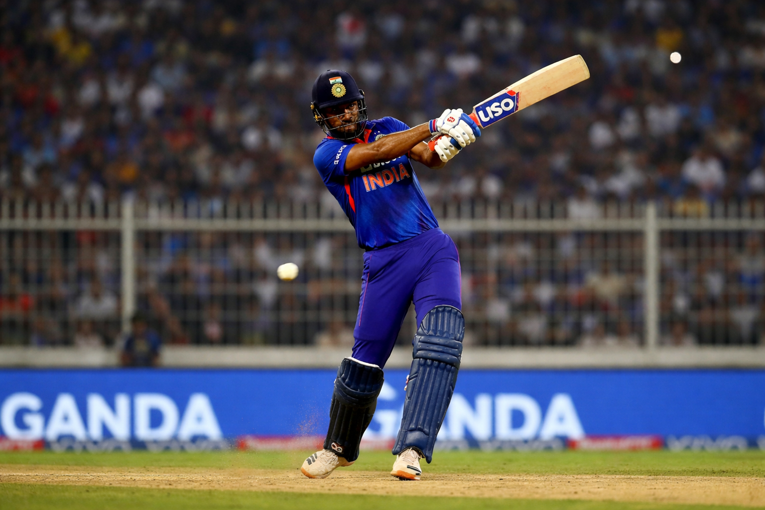 Indian batsman playing a powerful shot during a T20I Series match in an international cricket stadium